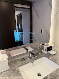 Mirror has digital front for Music Weather amenities and hotel information