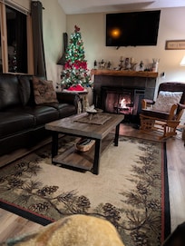 Upstairs living area with wood burning fireplace