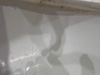 Under the rim of the sink