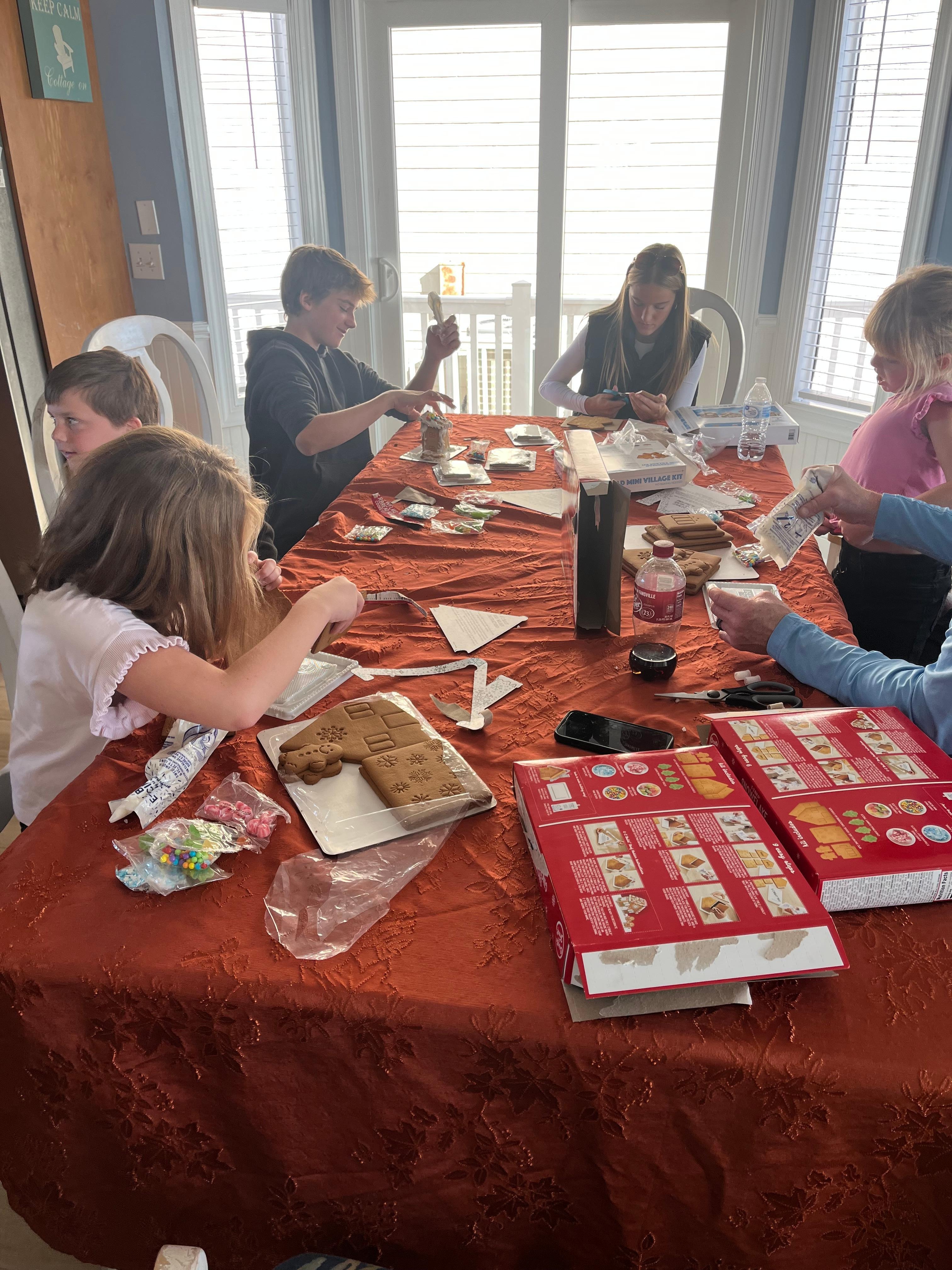 A huge table making gingerbread houses