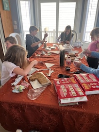 A huge table making gingerbread houses