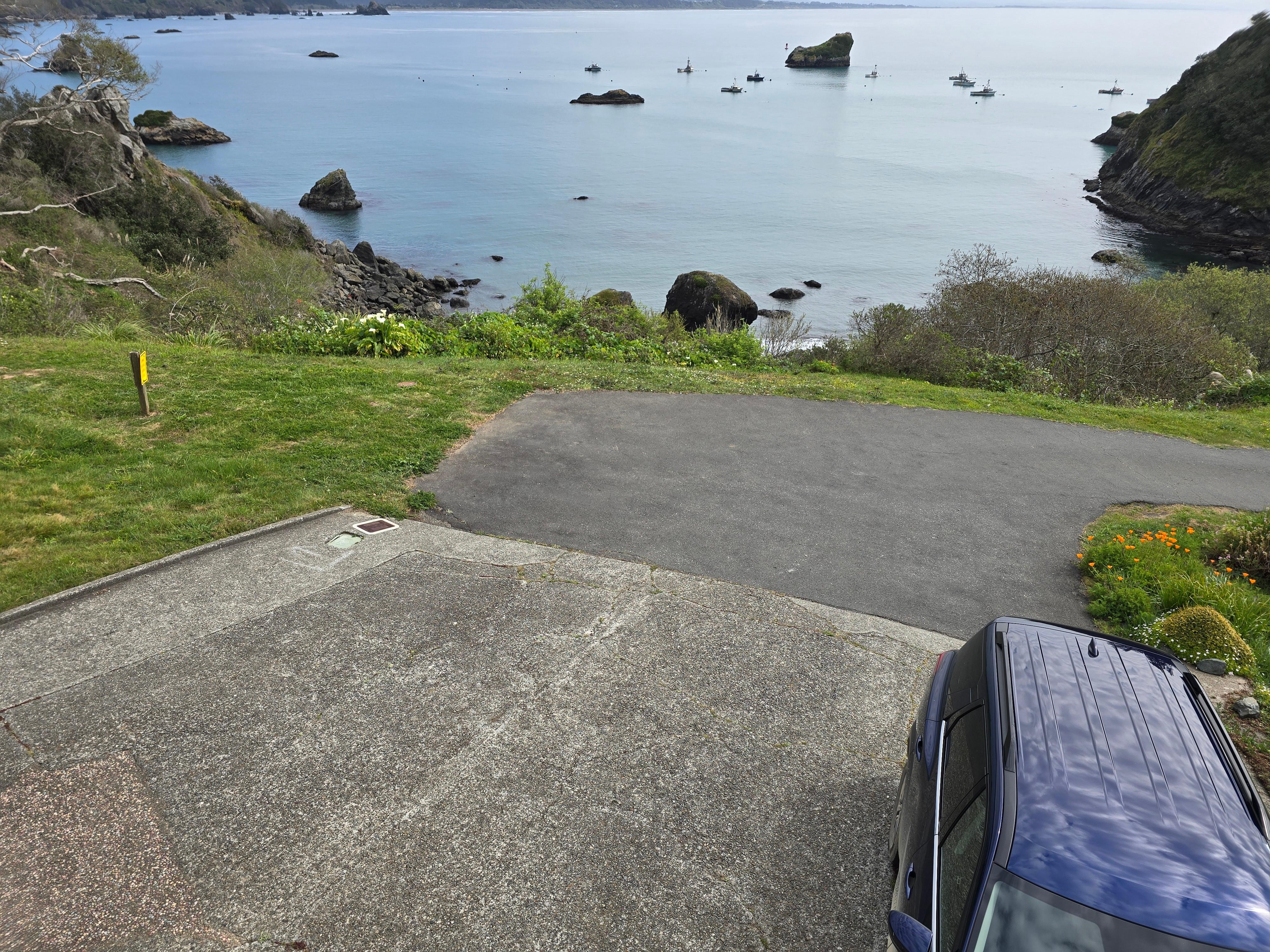 View from front deck down front driveway to street.  More parking beside and behind house.