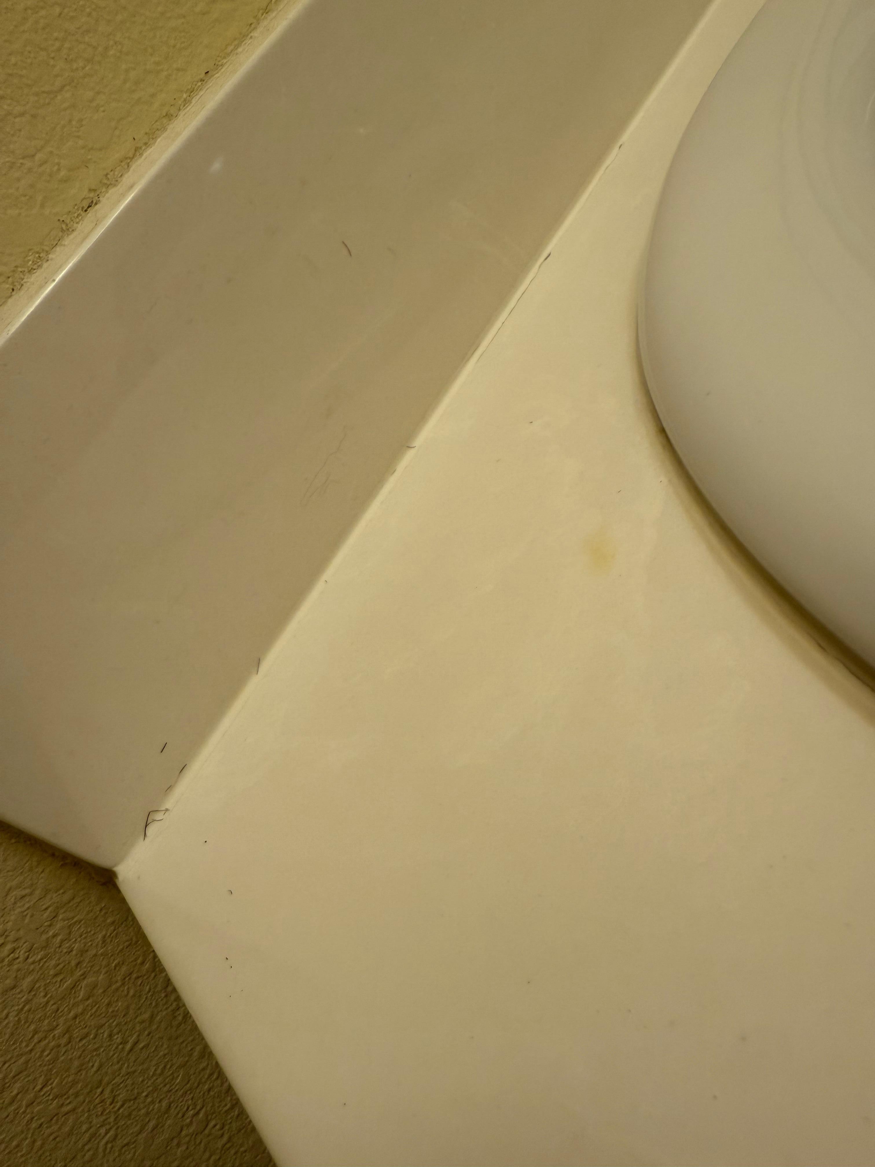 Hair around the sink and in the grooves 