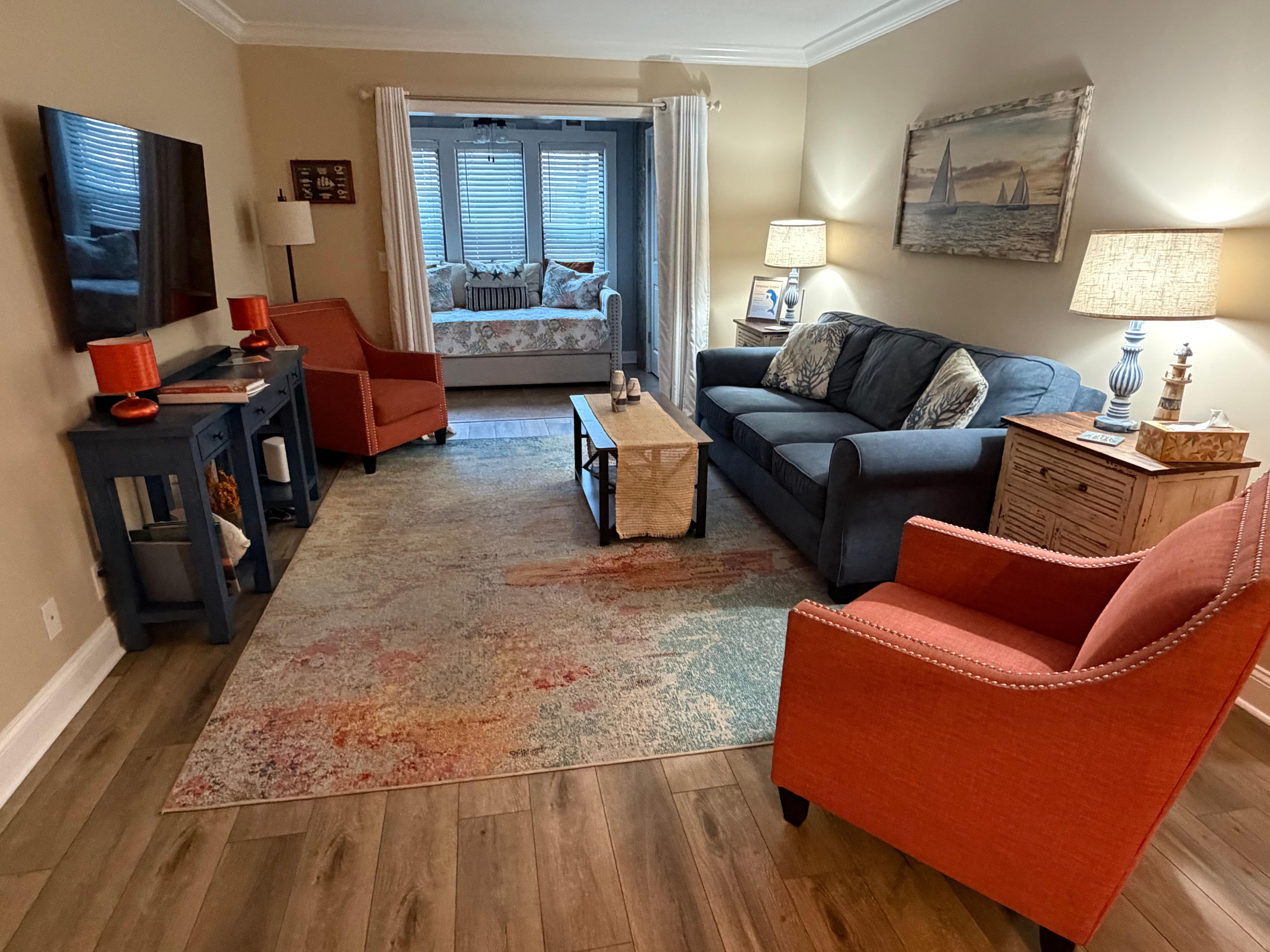 Living room area with trundle bed in separate alcove 