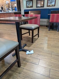 Wobbly table with napkin stuffed under it