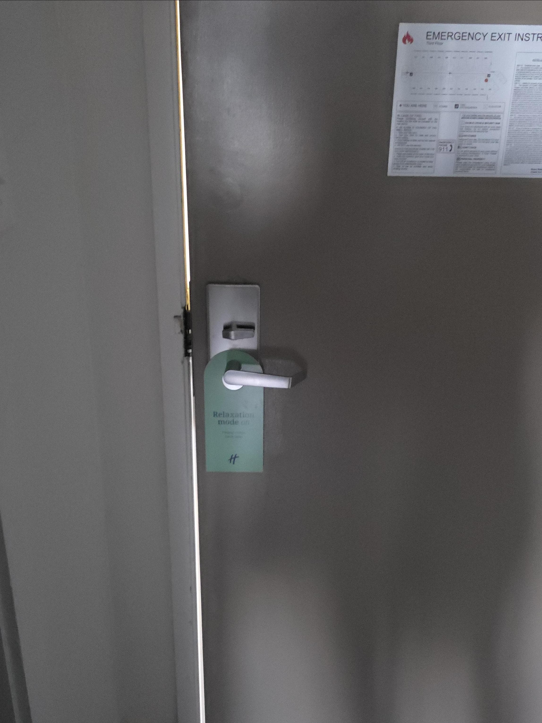 Rm 324, North Tower - gap in frame/door allowing bright light from exterior hallway to filter into interior of room