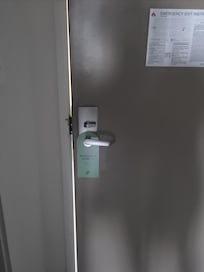 Rm 324, North Tower - gap in frame/door allowing bright light from exterior hallway to filter into interior of room