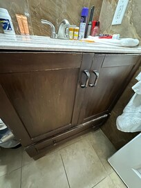 The bathroom vanity doors are disgusting. Zoom in.