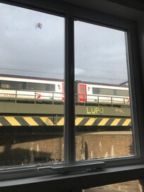 Trains pass every thirty seconds right outside the bedroom window