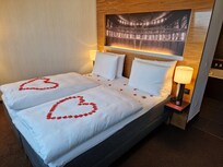 Extra package with flowers on bed and bathtub
