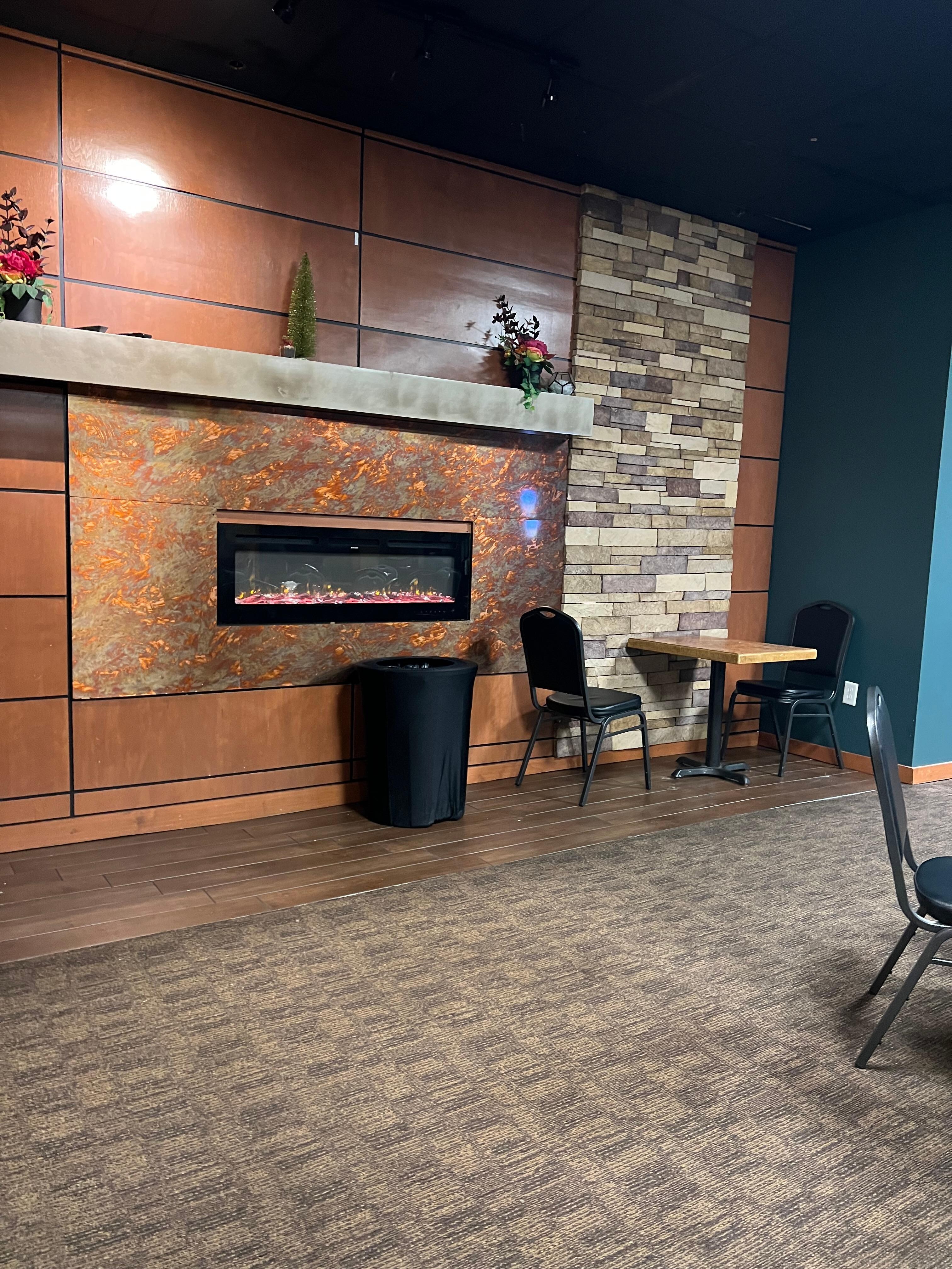 The modern fireplace lent an ambiance to the breakfast area.