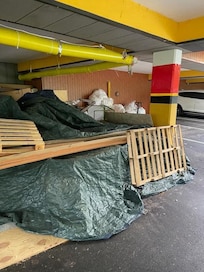 Massive amounts of trash strewn across the customer parking area