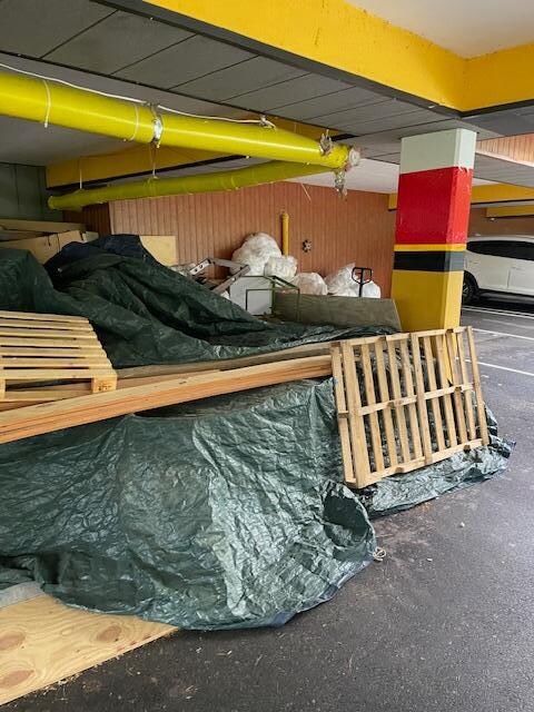 Massive amounts of trash strewn across the customer parking area
