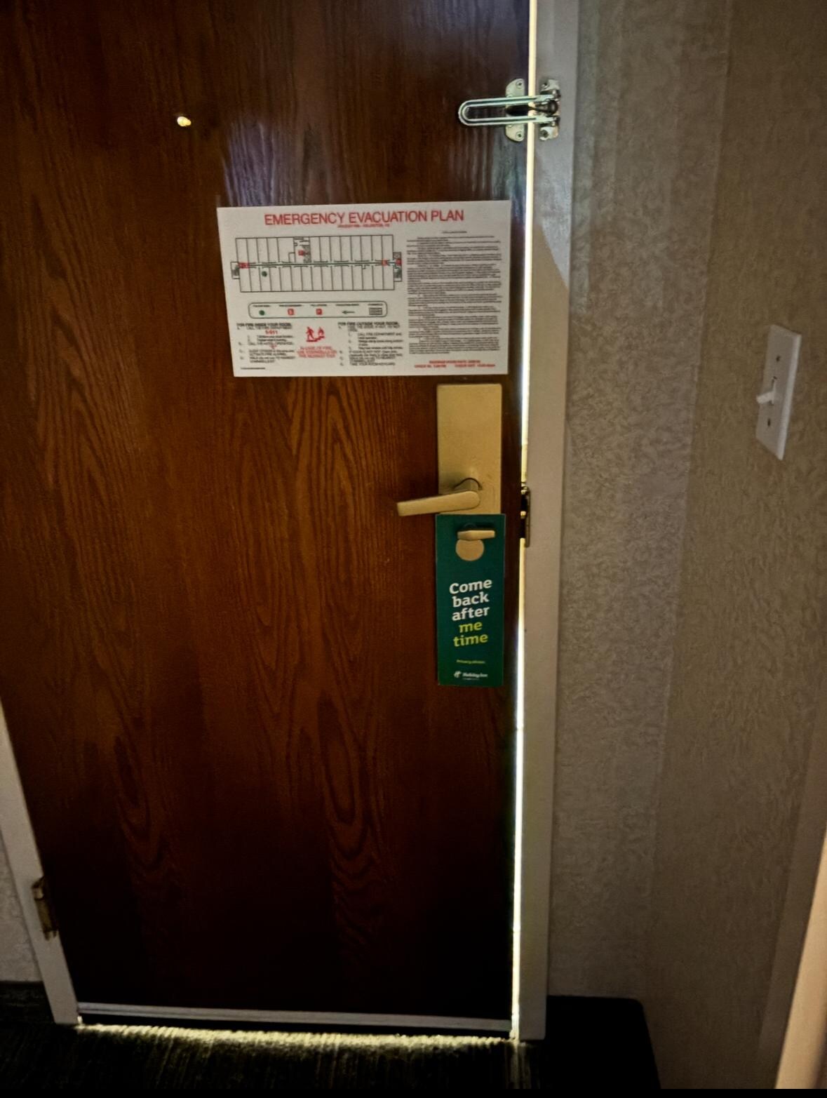 Room with no lights on. Large enough space/gaps between door/door frame. 