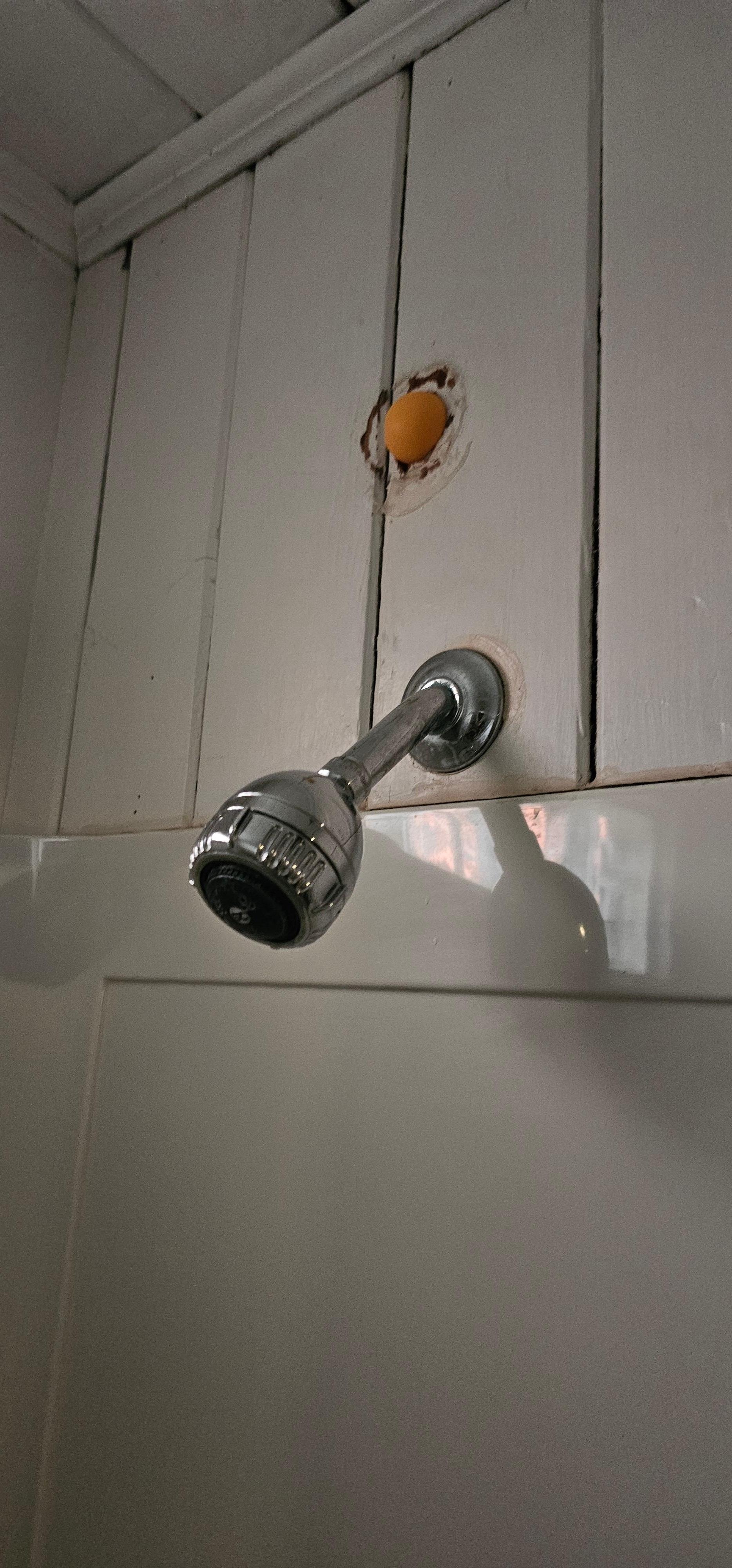 Orange plastic ball plugging wall hole