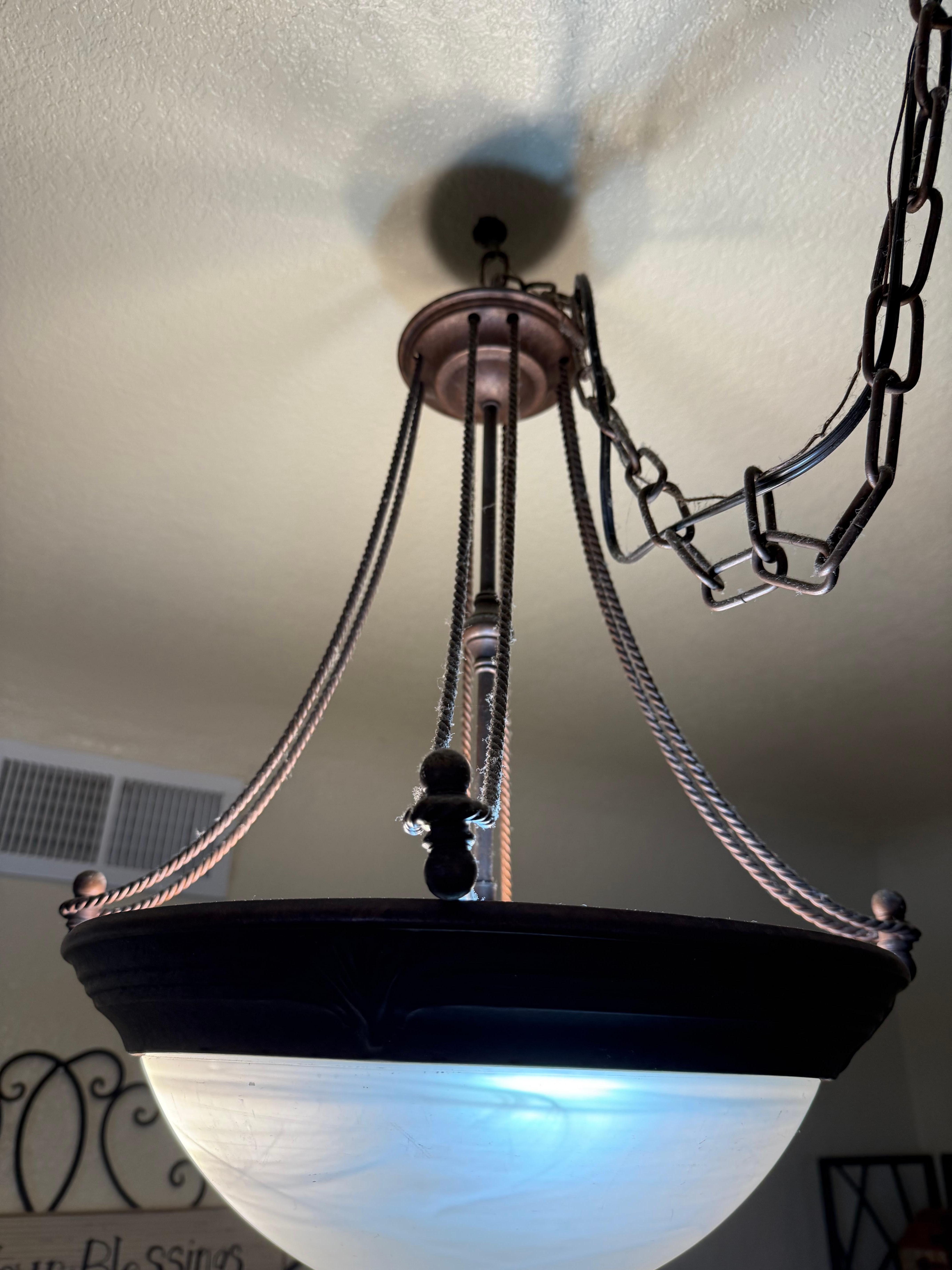 The dust covered fixture above the dining room table 