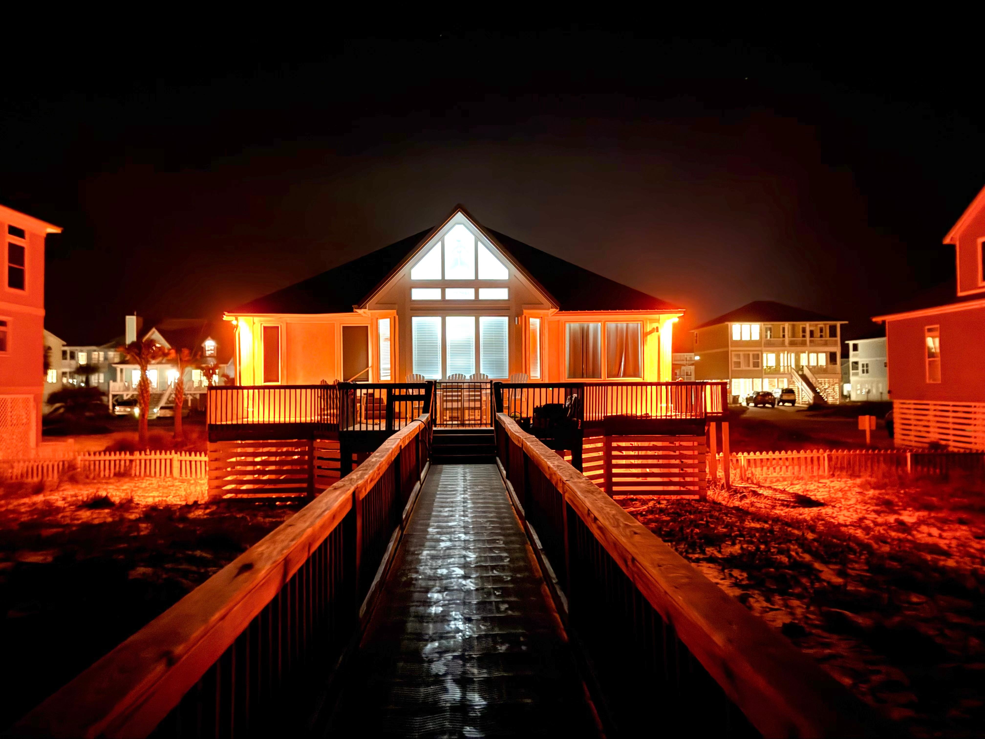 Nighttime view of  back deck from beacb