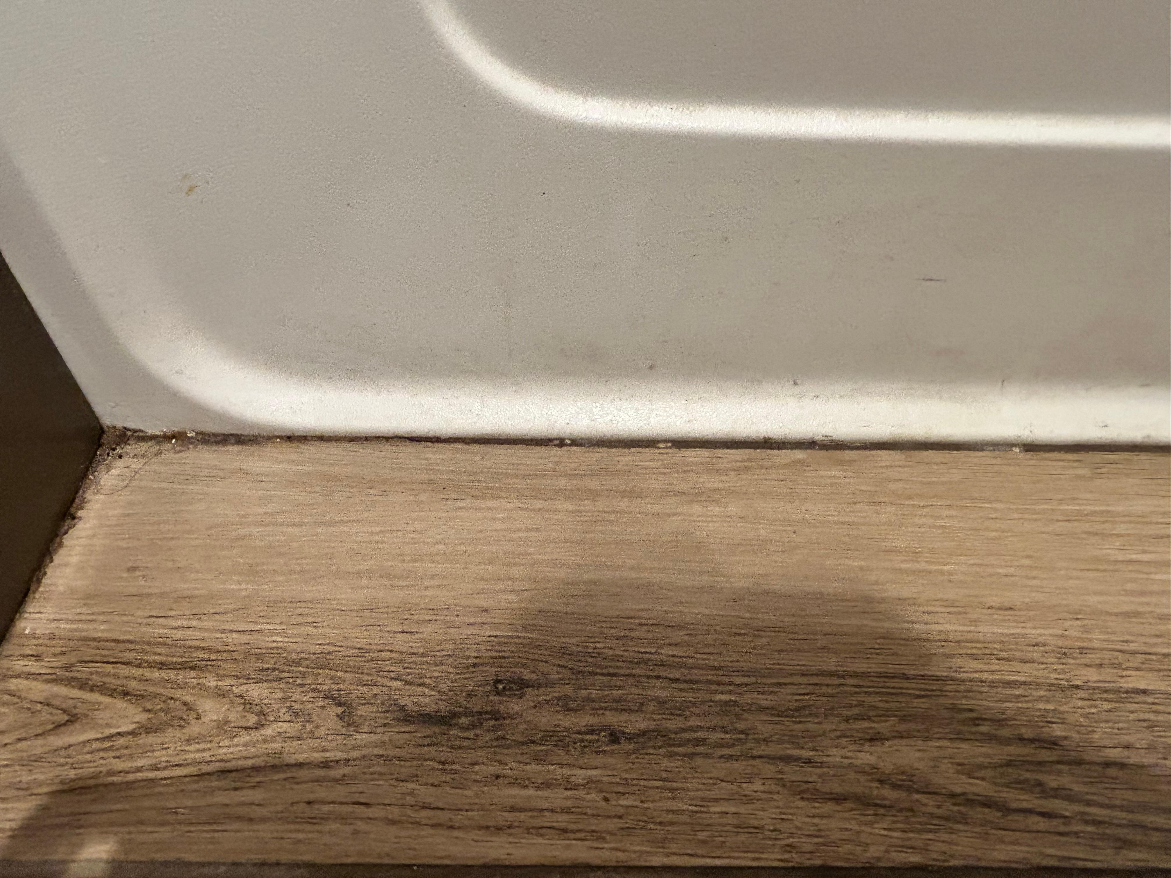 Corner of floor and side of tub