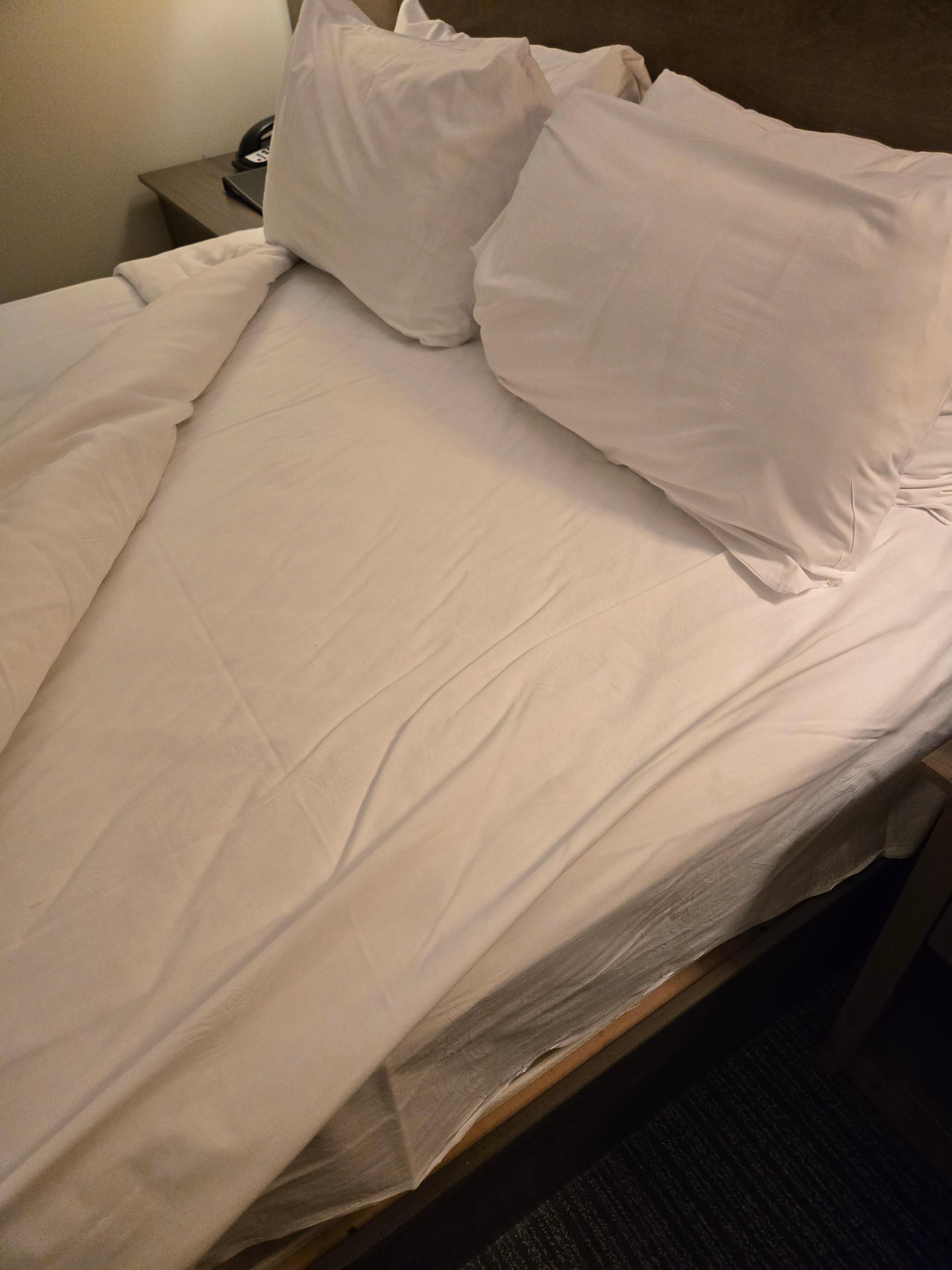 Room 208, dirty sheets that appeared slept in with a stain...