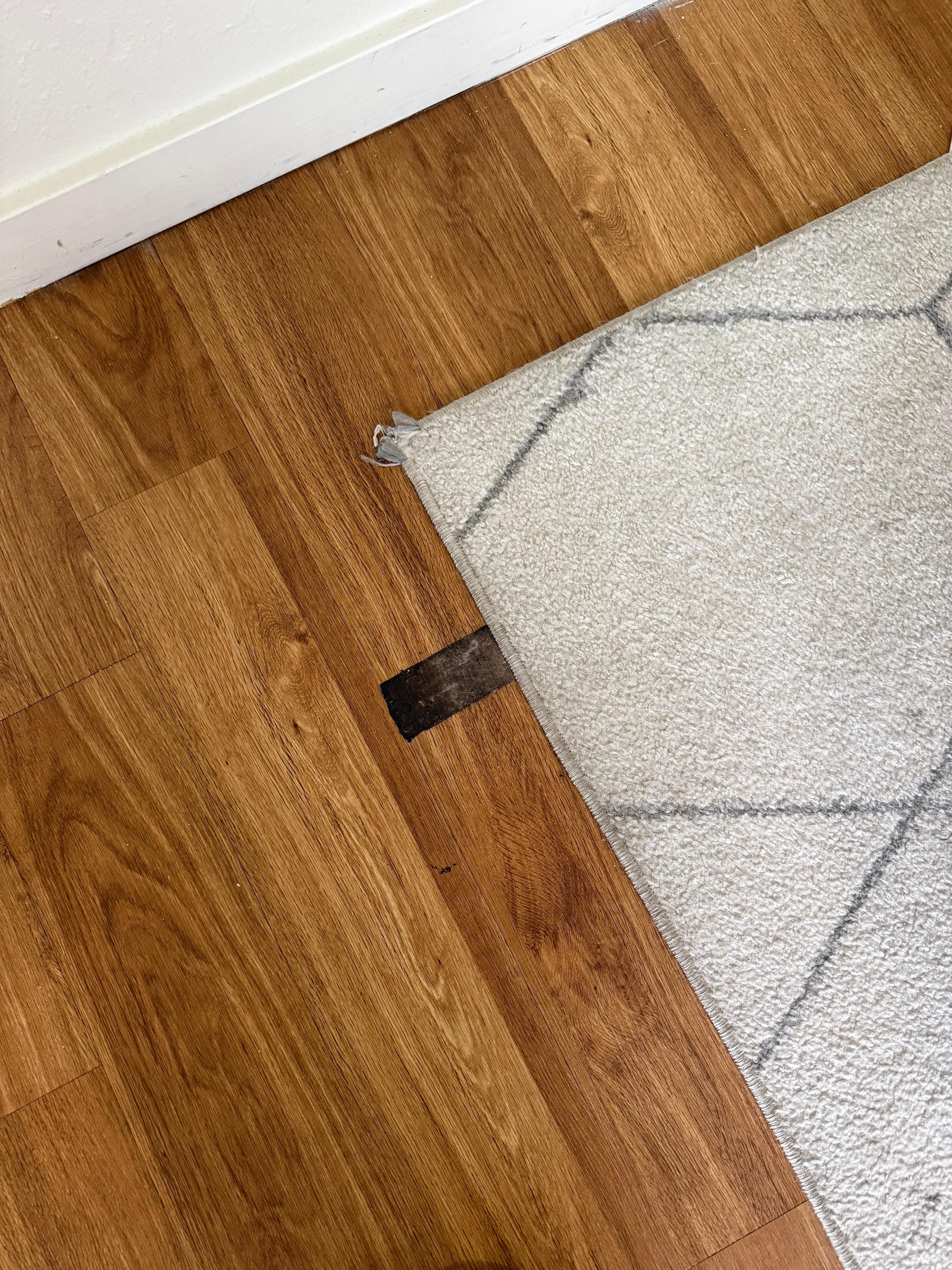 dirt glued to floor and grey stained rug