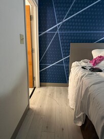 Space between the bed and bathroom door.