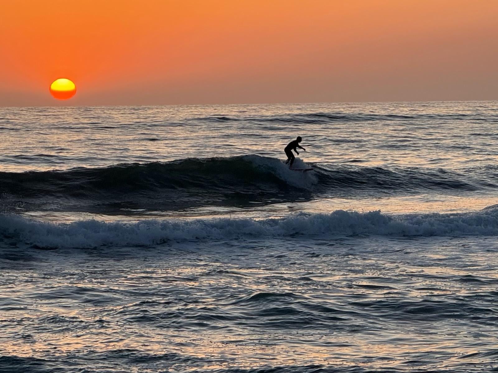 Sunset and surfer, photo taken from the beach in front of property. 