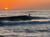 Sunset and surfer, photo taken from the beach in front of property.
