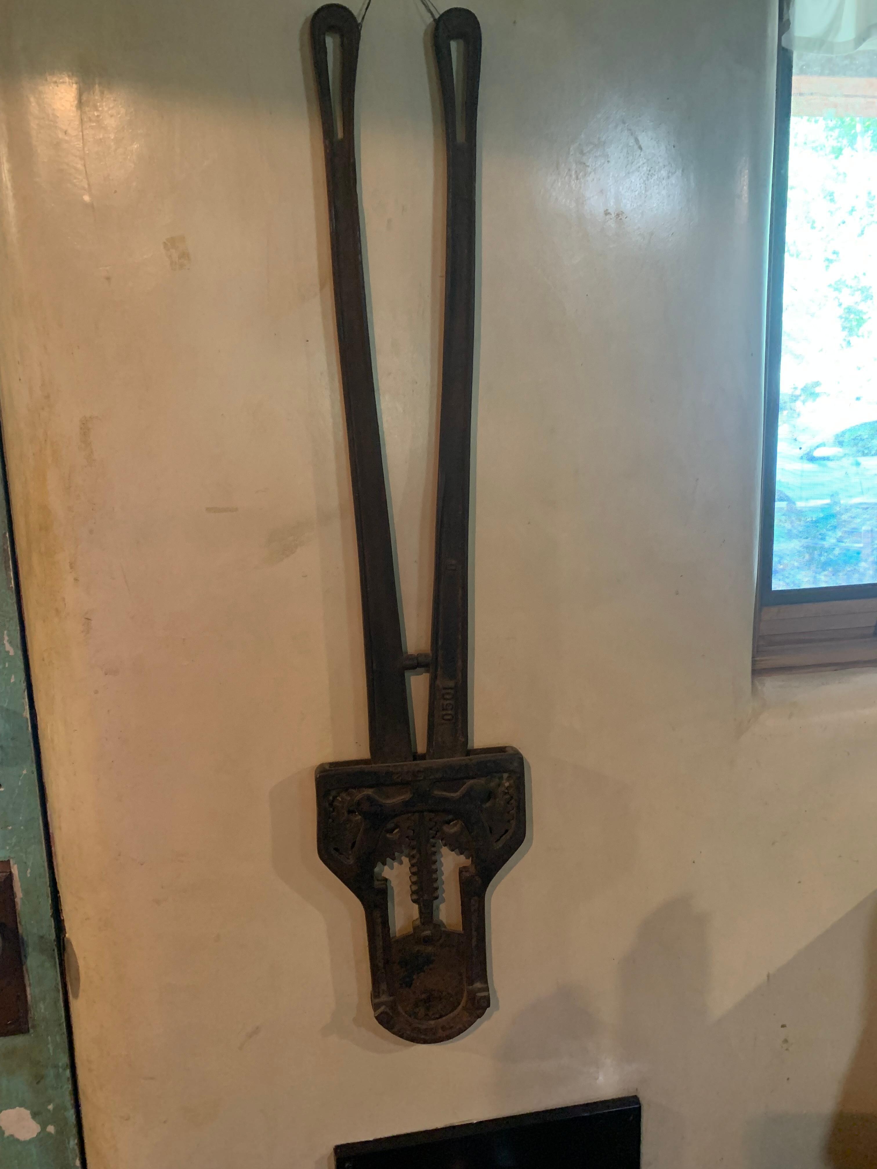 This is a tool to cut the horns off of cattle, a bloody chore. This is hanging in the kitchen. 