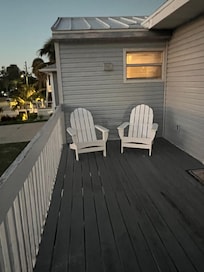 Front deck main entrance. Rotten decking. Different furniture than post