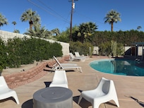 View from the far side of the patio looking toward the north end of the backyard, beautiful hard scape, lots of seating..great place to catch some sun.
