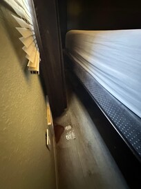 King size bed and curtains up against heater