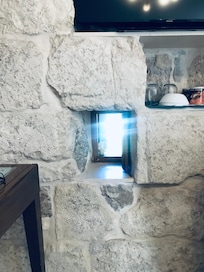 The small window seen from inside the room built into the wall from the Golden Gate!