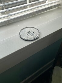 paint can lid left on windowsill in room