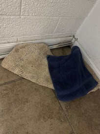 Put on the side of the tub folded up.