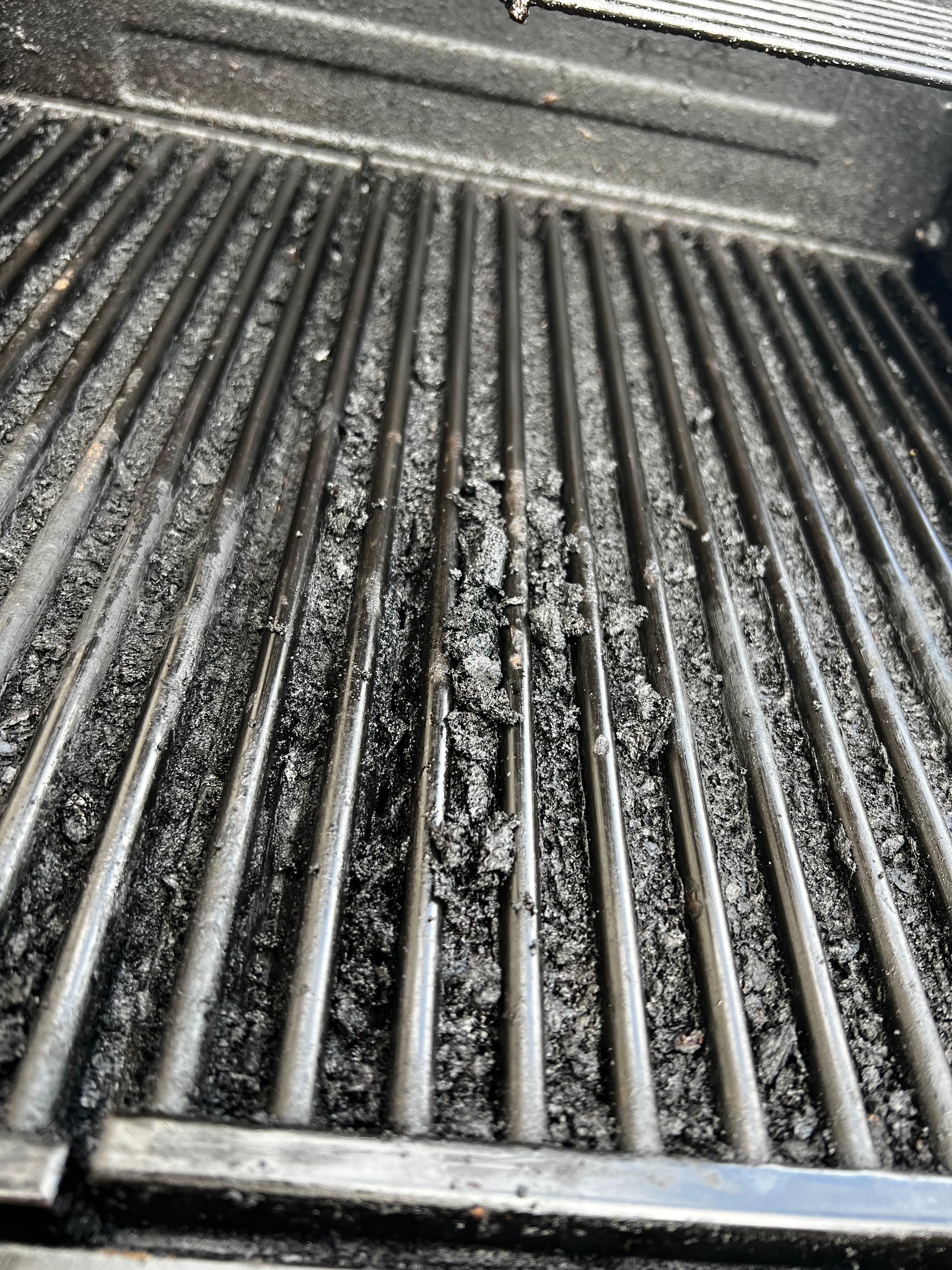 Used a table knife to scrape off some charred food/grease in grates to see how much buildup over grate holes.