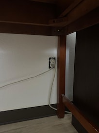 Exposed outlet next to fridge