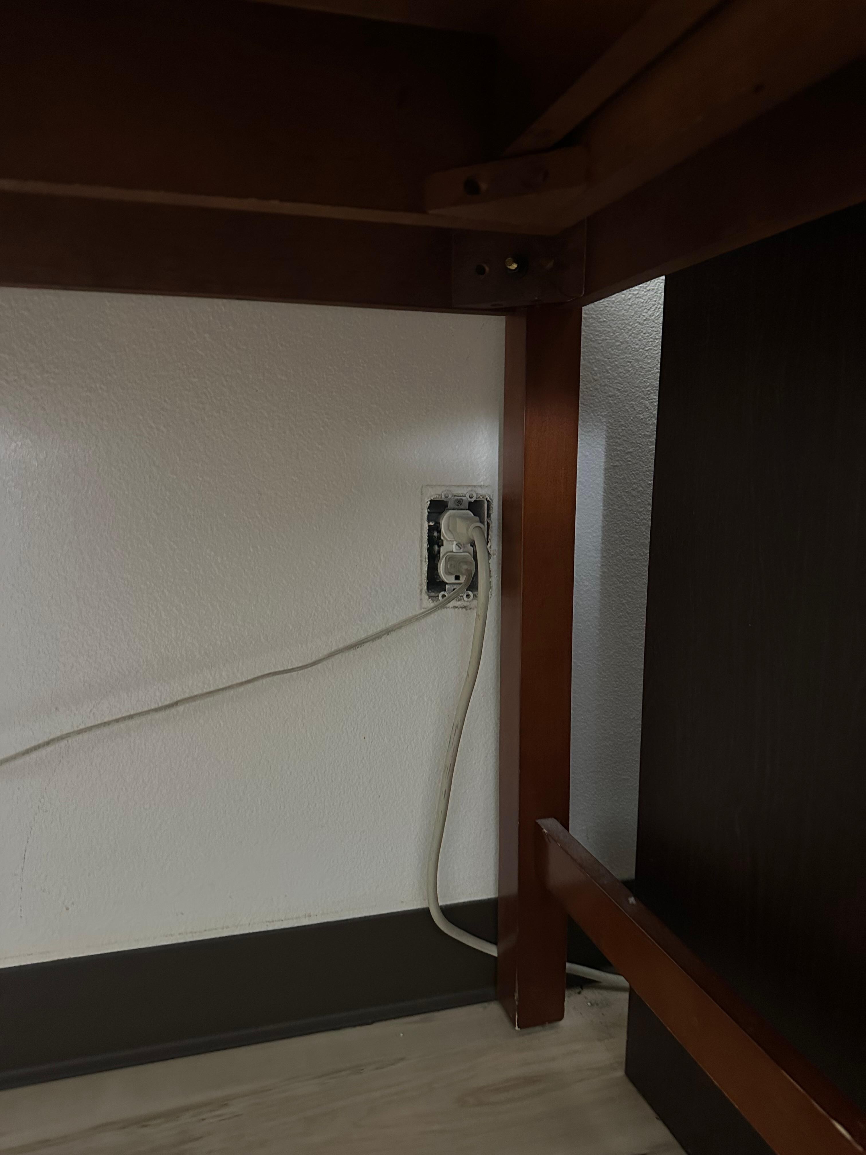 Exposed outlet next to fridge