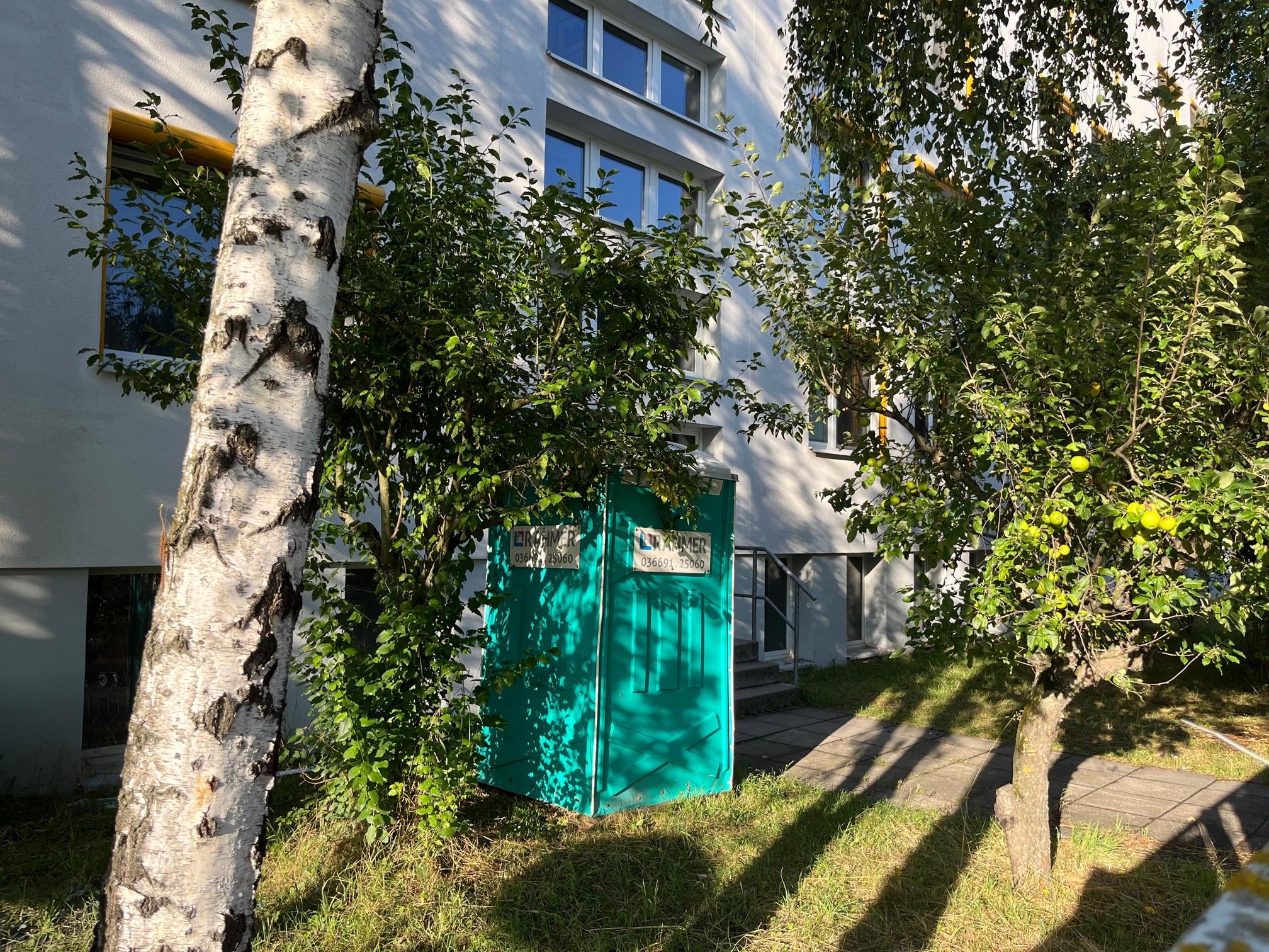 The portable toilet right outside the rooms.