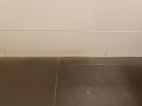Water leaking behind tiles with missing silicone