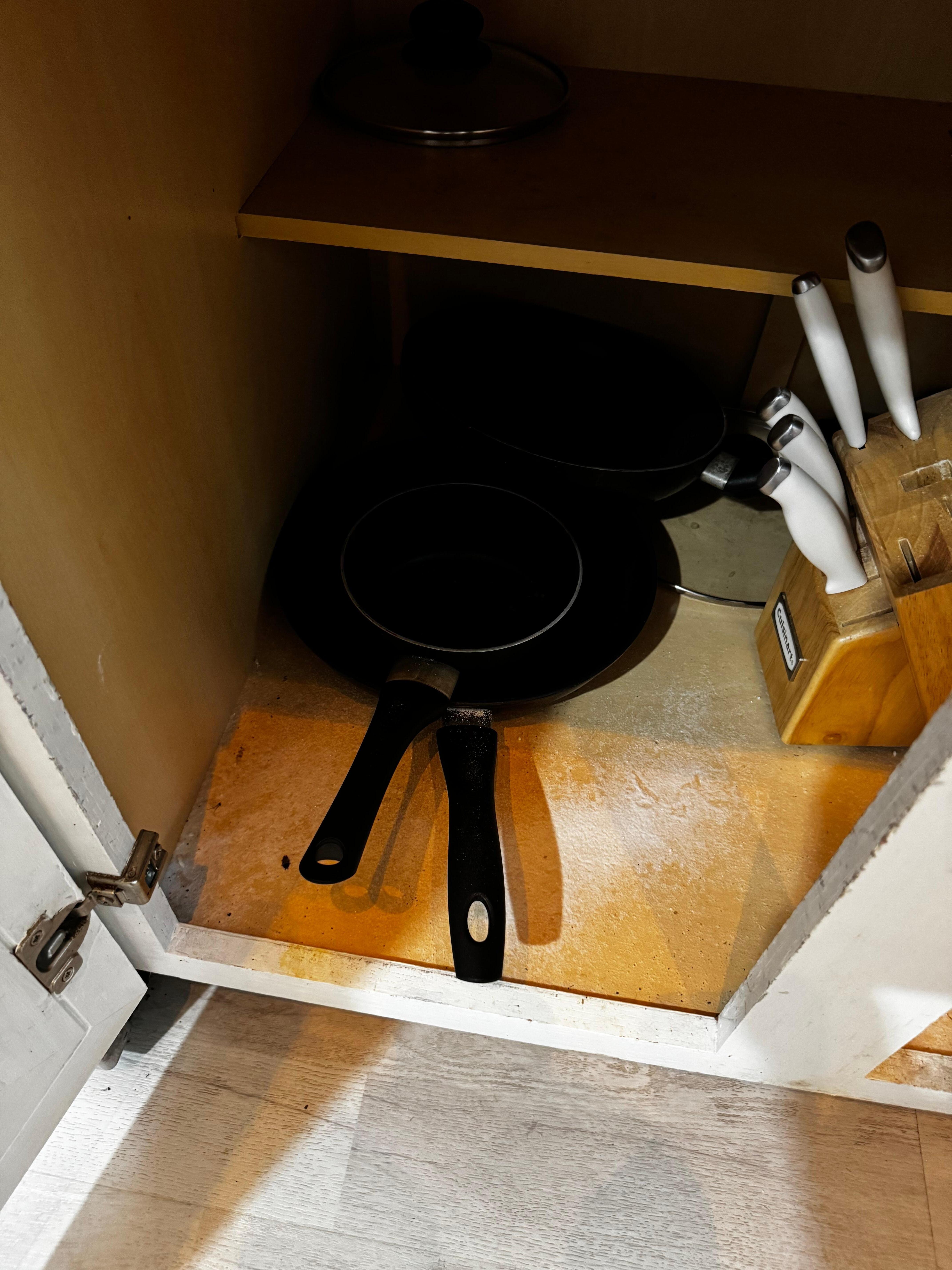 More dirty cabinets with insecticides sprinkled all around cooking utensils