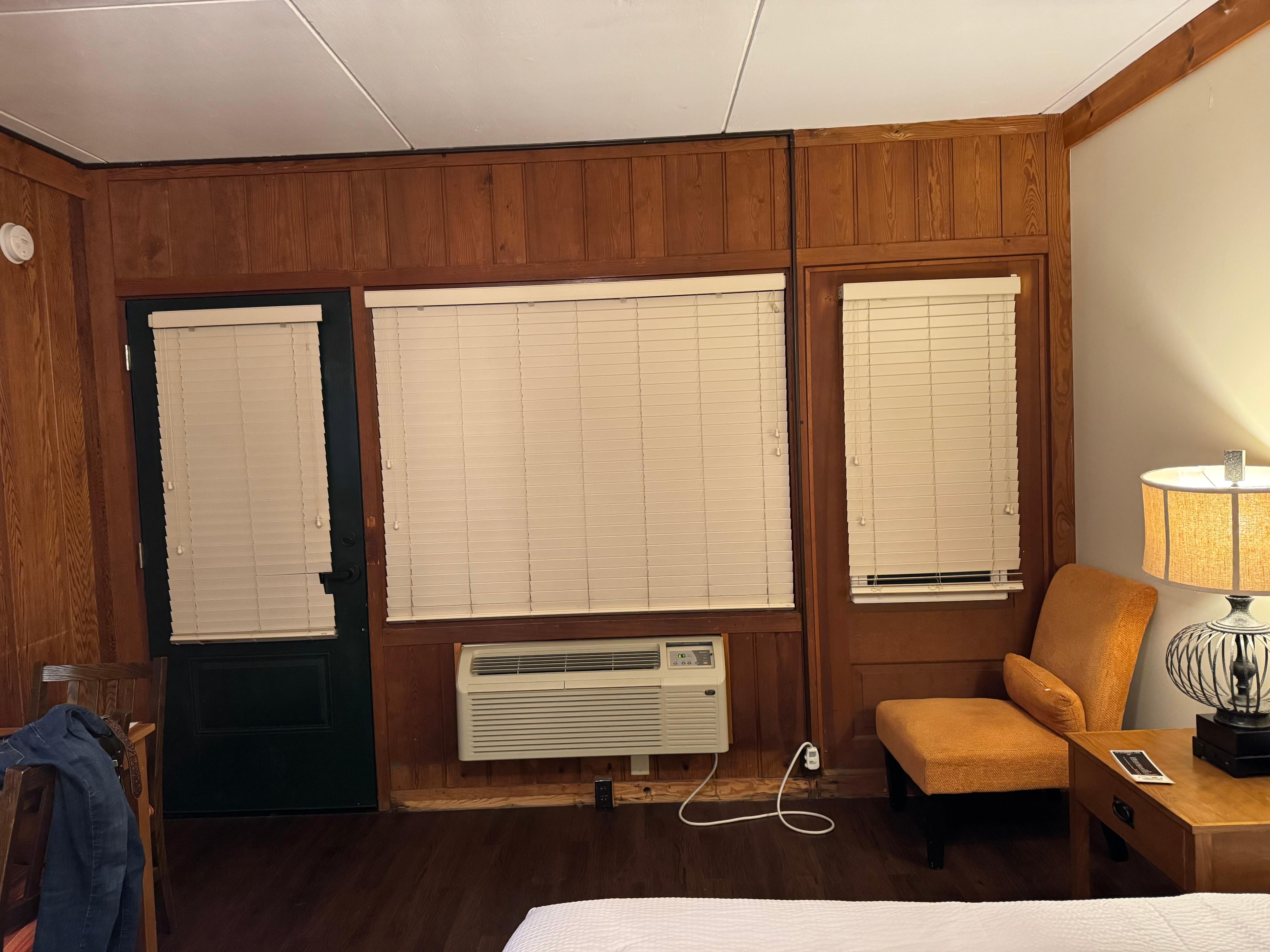 Cheap blinds, not curtains. Note how they're cut around the door handle and lock.