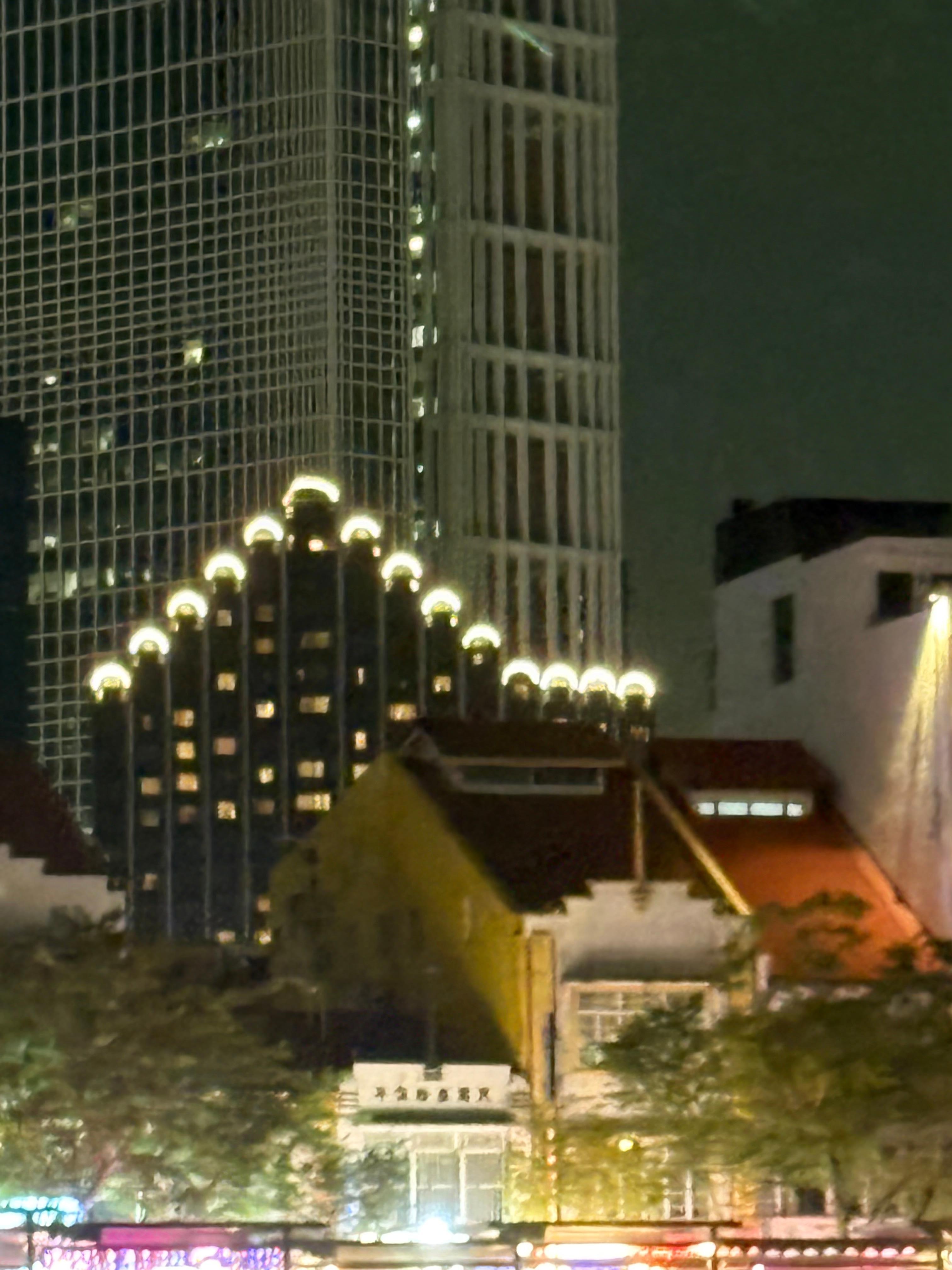 This is the Furama City Centre from the river at night. 