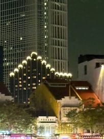 This is the Furama City Centre from the river at night.