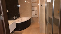 Jacuzzi bath and twin sinks and showers