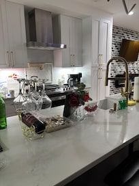 Kitchen that was fully stocked with bar stool for additional seating.