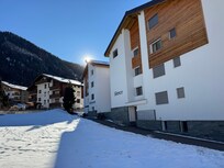 View from walkway heading toward bus stop and building