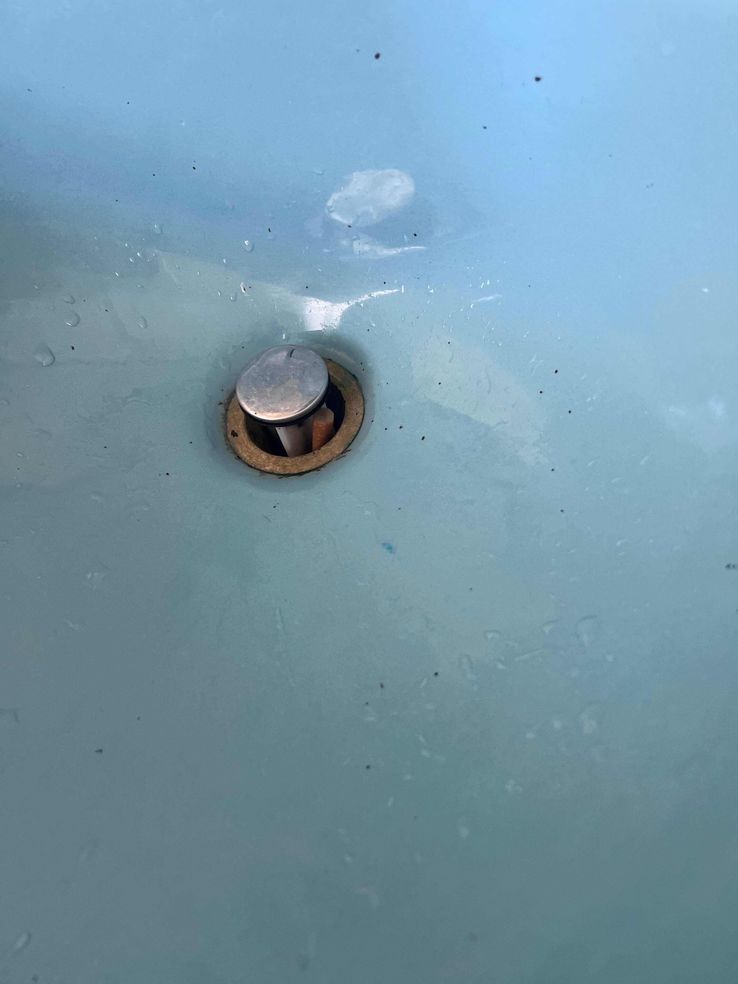 Cigarette shoved in sink drain