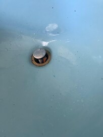 Cigarette shoved in sink drain