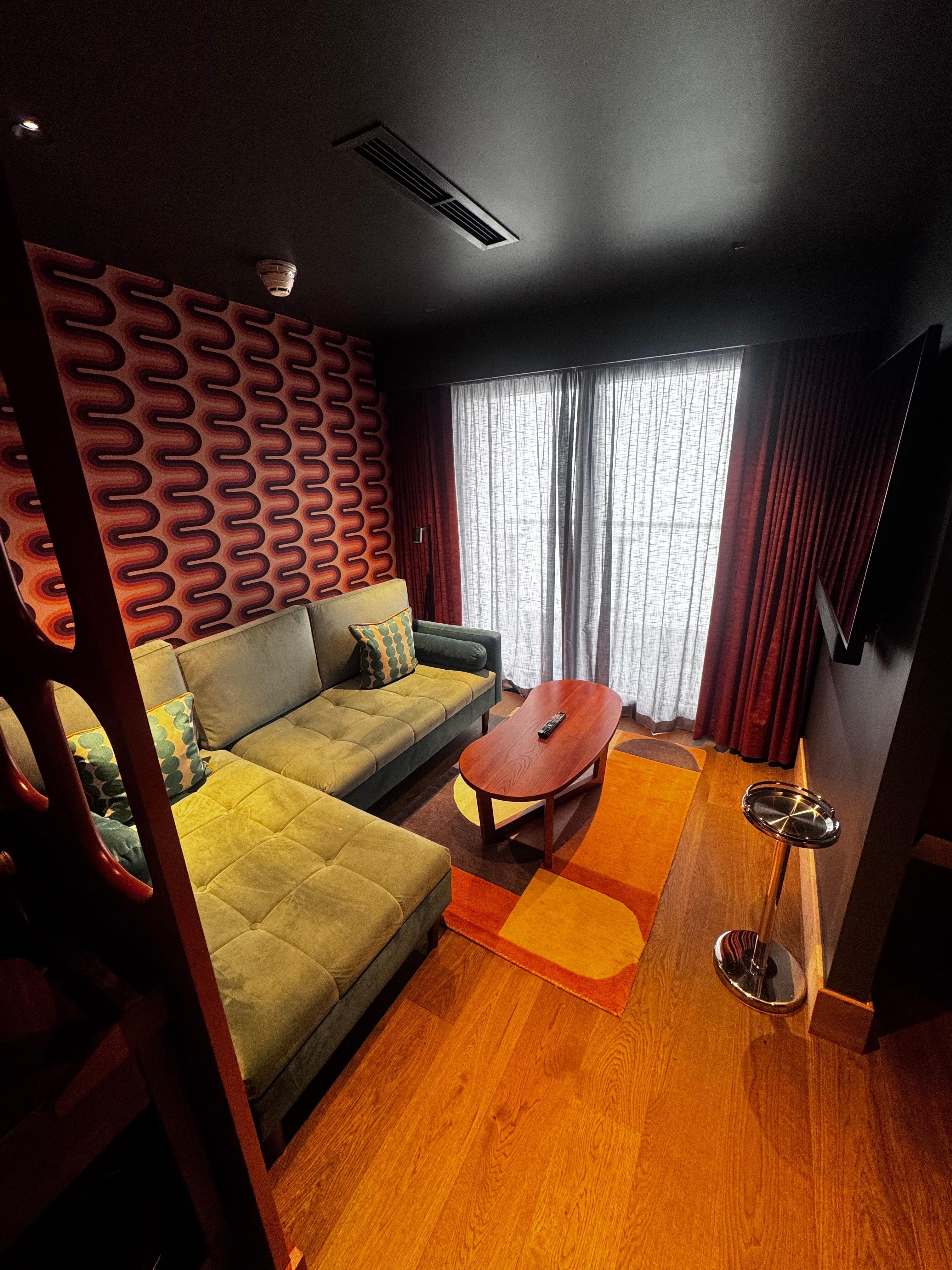 Corner couch in suite - room 605. Balcony at back of photo.