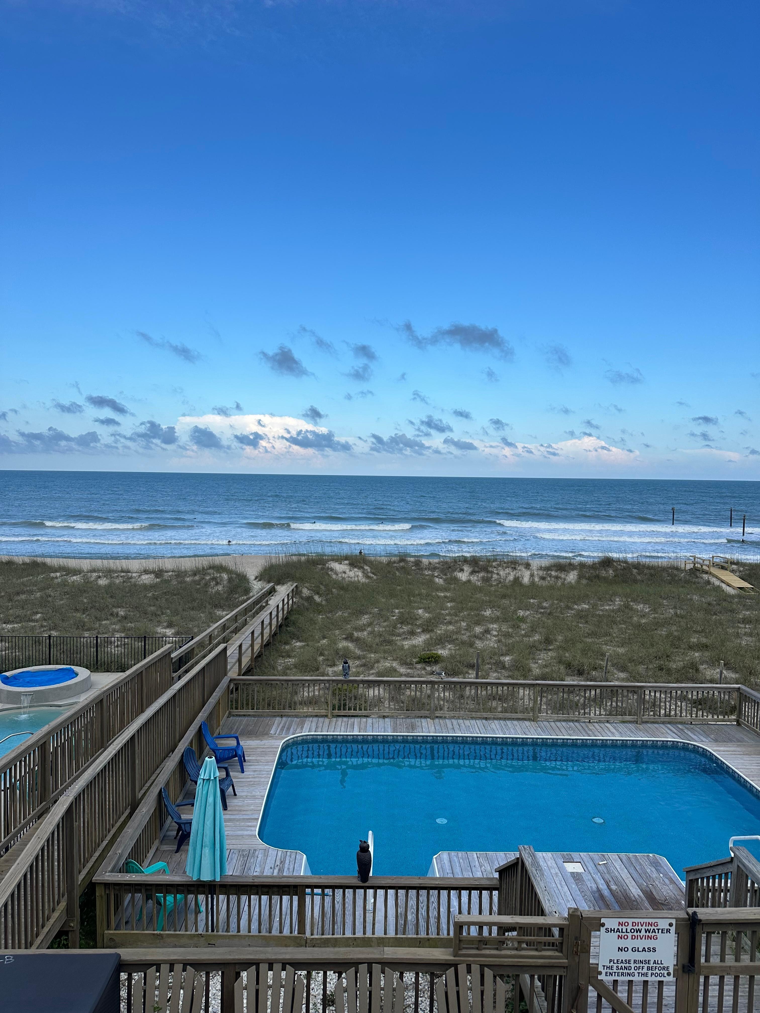 View of the pool, walkway, and ocean from the top balcony! Beautiful :)